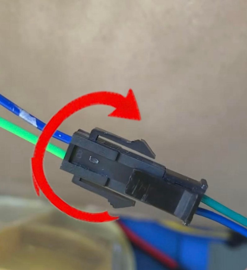 The two-wire connector after the swap: a blue and a green wire enter from the left and leave the joint with the colors reversed