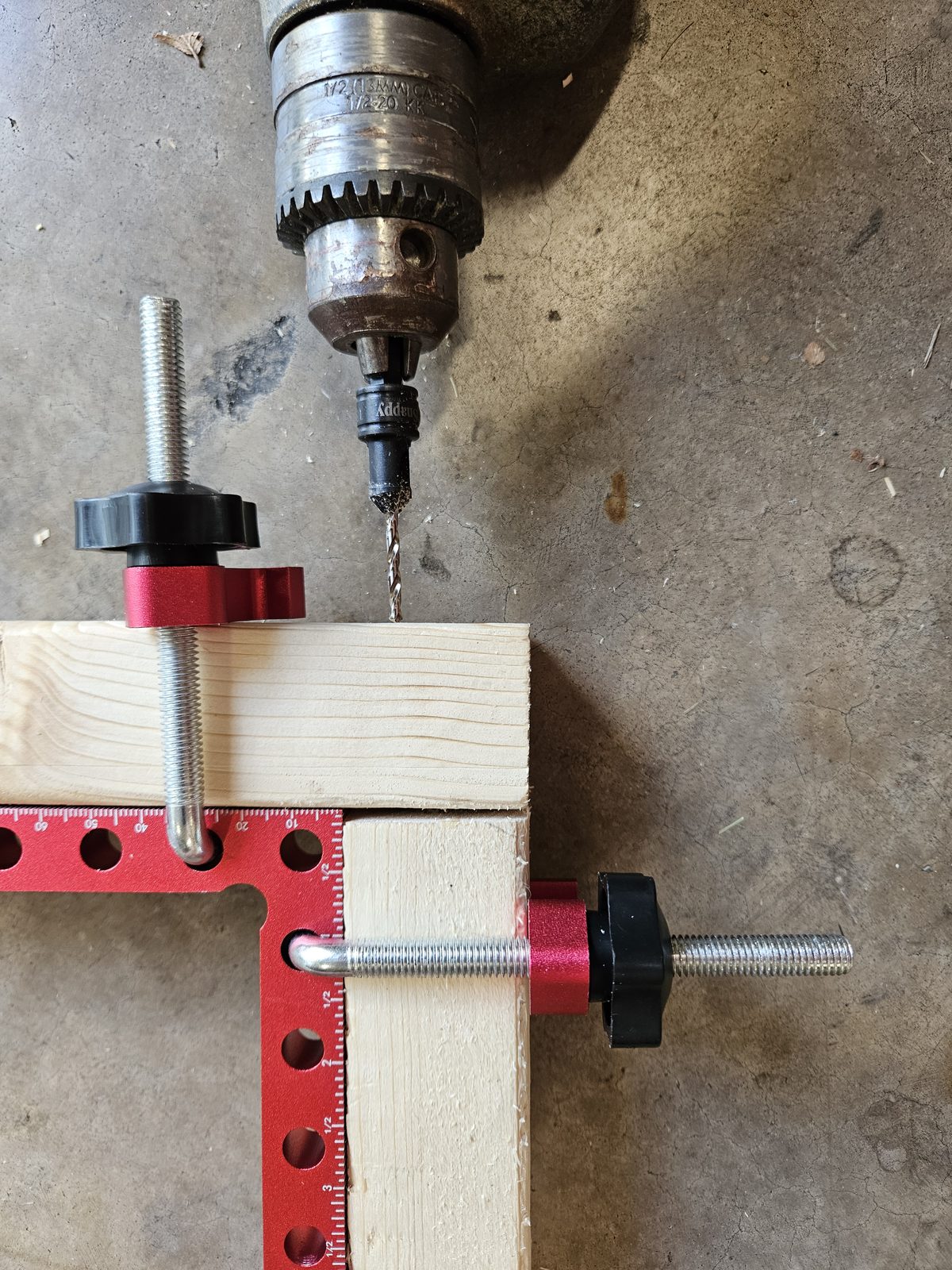 Drilling a combined pilot hole and countersink at a clamped frame corner
